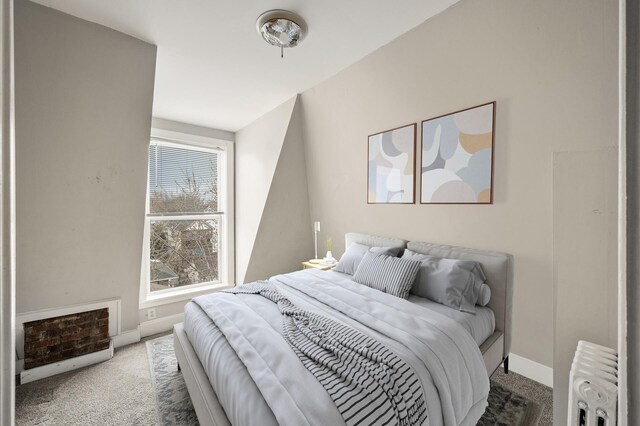 carpeted bedroom featuring baseboards, heating unit, and radiator
