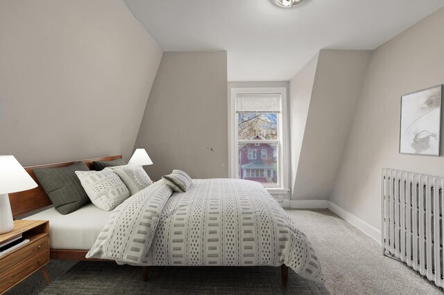 carpeted bedroom featuring baseboards and radiator heating unit