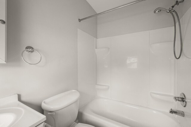 bathroom featuring toilet, tub / shower combination, and vanity