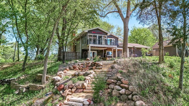 9158 Collins Dr NW, Ramsey, MN 55303 - back of property featuring a sunroom, a deck, and fence