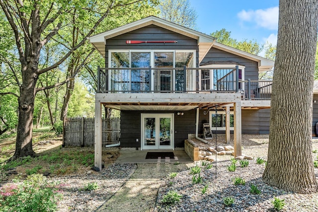 9158 Collins Dr NW, Ramsey, MN 55303 - rear view of property featuring a wooden deck, french doors, fence, and a sunroom