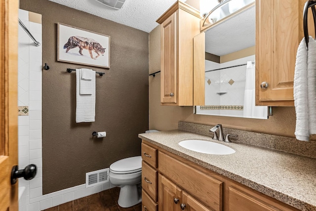 9158 Collins Dr NW, Ramsey, MN 55303 - full bathroom featuring a textured ceiling, wood finished floors, toilet, vanity, and baseboards