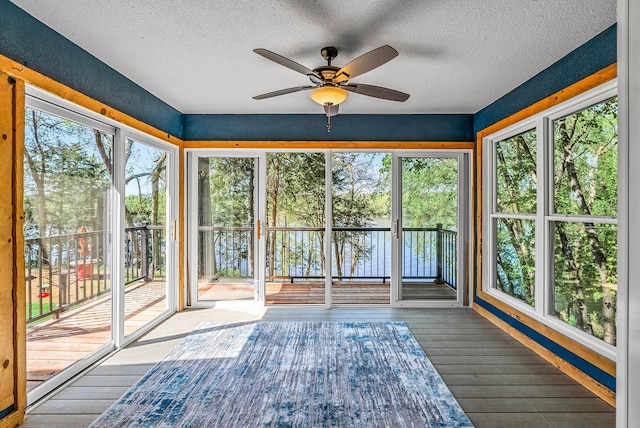 9158 Collins Dr NW, Ramsey, MN 55303 - unfurnished sunroom featuring a textured ceiling, hardwood / wood-style floors, and a deck