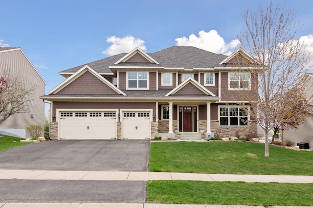 2919 Hilltop Dr, Chaska, MN 55318 - craftsman-style house featuring asphalt driveway, a front lawn, stone siding, and roof with shingles