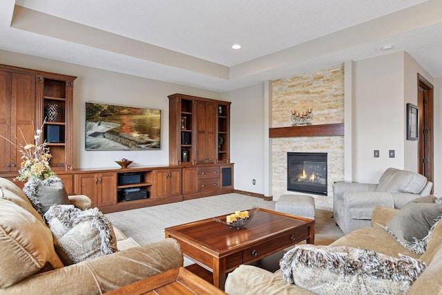 2919 Hilltop Dr, Chaska, MN 55318 - carpeted living area with a stone fireplace, a tray ceiling, recessed lighting, and baseboards