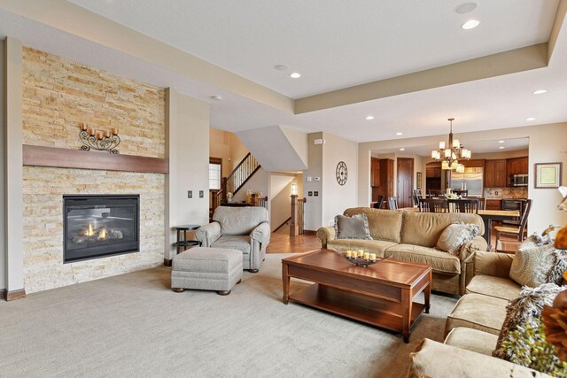 2919 Hilltop Dr, Chaska, MN 55318 - carpeted living area with recessed lighting, a fireplace, stairway, and a chandelier