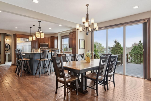 2919 Hilltop Dr, Chaska, MN 55318 - dining space with hardwood / wood-style floors, a chandelier, arched walkways, and recessed lighting