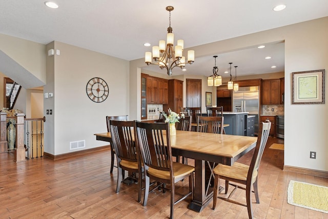 2919 Hilltop Dr, Chaska, MN 55318 - dining area featuring light wood-style flooring, recessed lighting, baseboards, and a chandelier