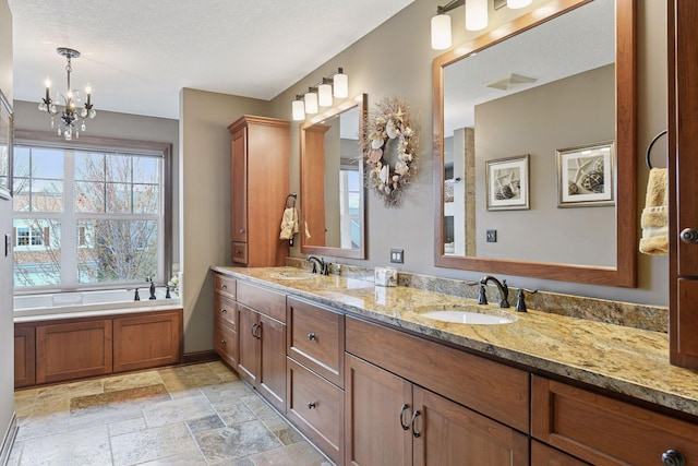 2919 Hilltop Dr, Chaska, MN 55318 - full bath featuring a chandelier, stone tile flooring, double vanity, and a garden tub