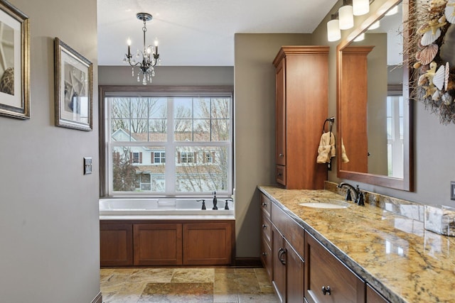2919 Hilltop Dr, Chaska, MN 55318 - full bath with a chandelier, vanity, a garden tub, and stone finish flooring