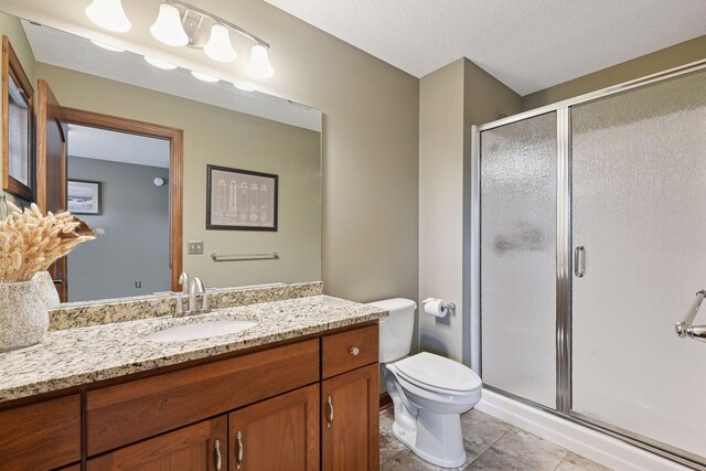 2919 Hilltop Dr, Chaska, MN 55318 - full bathroom with a stall shower, vanity, toilet, tile patterned floors, and a textured ceiling