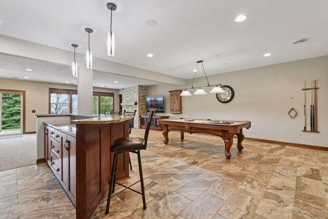2919 Hilltop Dr, Chaska, MN 55318 - kitchen featuring healthy amount of natural light, light stone finish flooring, pool table, a kitchen breakfast bar, and recessed lighting