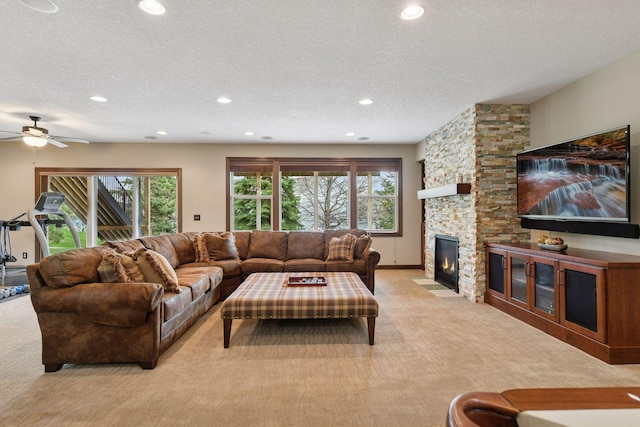 2919 Hilltop Dr, Chaska, MN 55318 - living room featuring light carpet, recessed lighting, a stone fireplace, healthy amount of natural light, and a textured ceiling