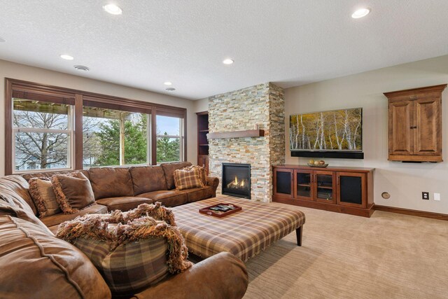 2919 Hilltop Dr, Chaska, MN 55318 - living room with recessed lighting, a textured ceiling, light carpet, a stone fireplace, and baseboards