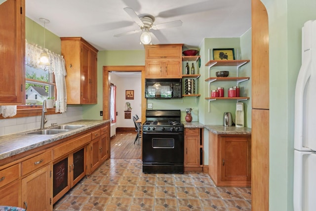 kitchen with black appliances, a sink, a ceiling fan, tasteful backsplash, and brown cabinetry