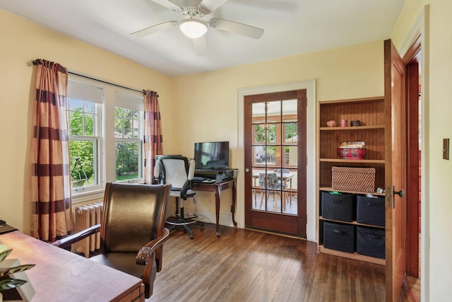 office space with radiator, wood finished floors, and a ceiling fan