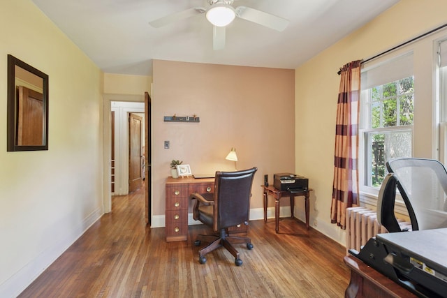 office with wood-type flooring, a ceiling fan, and baseboards