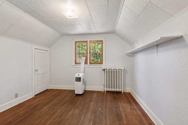 bonus room with radiator, dark wood-style flooring, lofted ceiling, and baseboards