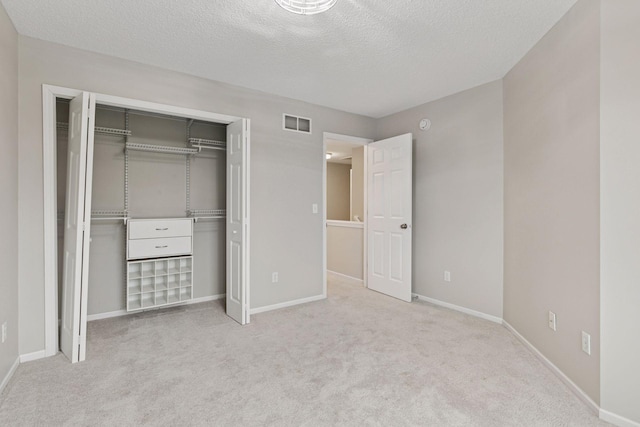 unfurnished bedroom with a closet, carpet, baseboards, and visible vents