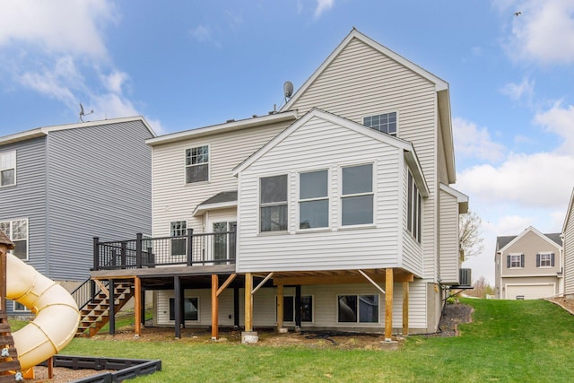 rear view of house with a yard, cooling unit, a wooden deck, and stairs