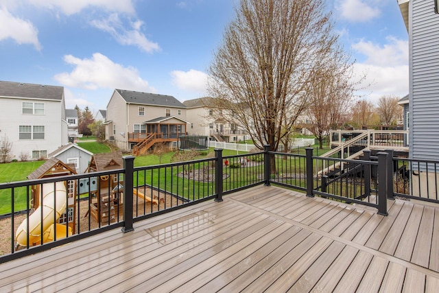 deck featuring a residential view, a storage unit, stairs, and an outbuilding