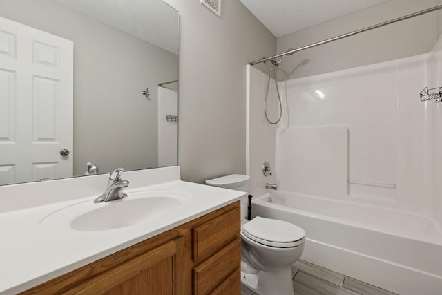 2348 Kelm St, Chaska, MN 55318 - full bathroom with a textured ceiling, visible vents, shower / washtub combination, vanity, and toilet
