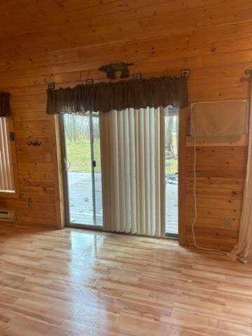 19675 Woody Ln NE, Kelliher, MN 56650 - empty room featuring light wood finished floors and wood walls