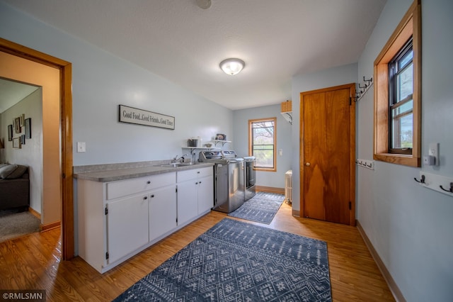 300 Carlson Rd, Cannon Falls, MN 55009 - clothes washing area featuring laundry area, washer / dryer, a sink, baseboards, and light wood-type flooring