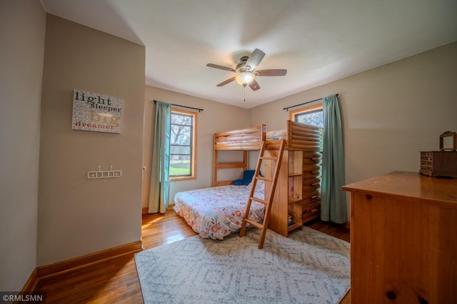 300 Carlson Rd, Cannon Falls, MN 55009 - bedroom featuring multiple windows, ceiling fan, wood finished floors, and baseboards