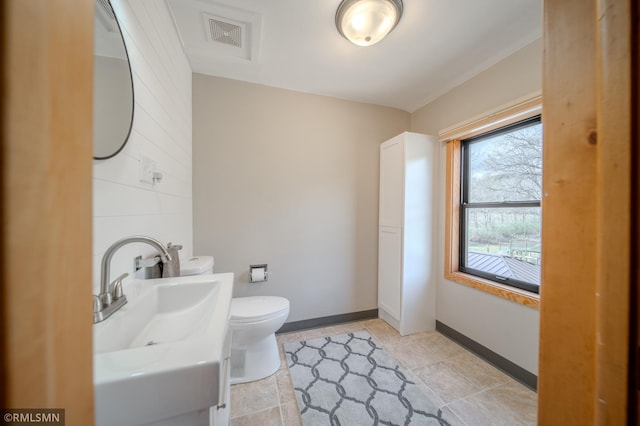 300 Carlson Rd, Cannon Falls, MN 55009 - half bathroom with baseboards, visible vents, toilet, and vanity