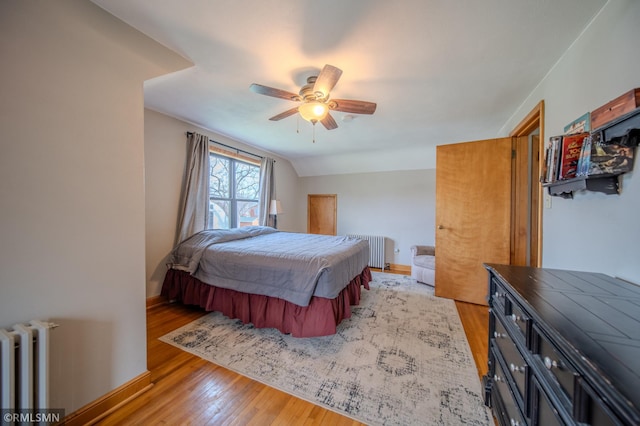300 Carlson Rd, Cannon Falls, MN 55009 - bedroom featuring ceiling fan, light wood finished floors, and radiator