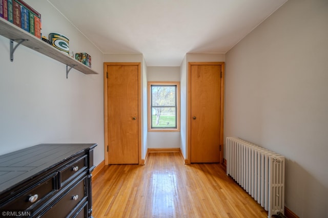 300 Carlson Rd, Cannon Falls, MN 55009 - unfurnished bedroom featuring baseboards, radiator heating unit, and light wood-type flooring
