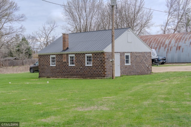 300 Carlson Rd, Cannon Falls, MN 55009 - view of side of property featuring a lawn, a chimney, and metal roof