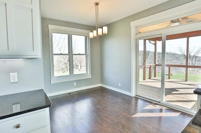 203 Walnut Hill Way, Troy Twp, WI 54022 - unfurnished dining area with baseboards, a chandelier, a healthy amount of sunlight, and dark wood-type flooring