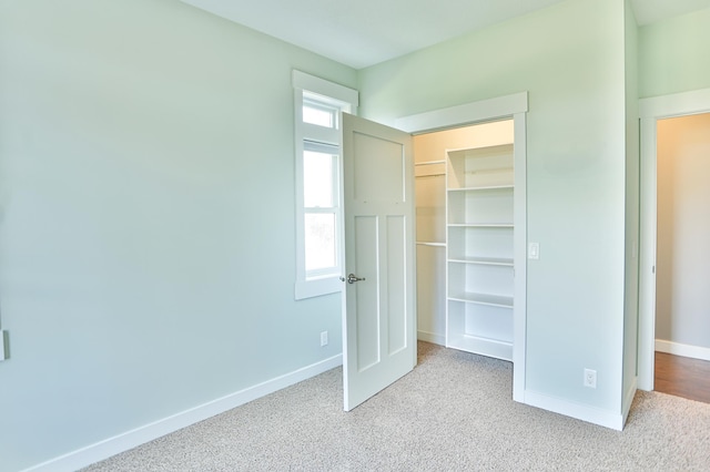 203 Walnut Hill Way, Troy Twp, WI 54022 - unfurnished bedroom featuring carpet floors, baseboards, a walk in closet, and a closet