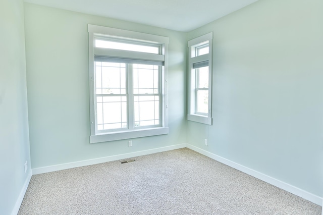 203 Walnut Hill Way, Troy Twp, WI 54022 - spare room featuring visible vents, carpet, and baseboards