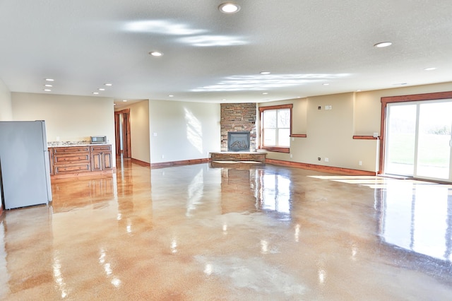 203 Walnut Hill Way, Troy Twp, WI 54022 - spare room with recessed lighting, baseboards, a fireplace, and concrete floors