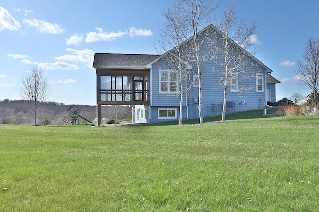 203 Walnut Hill Way, Troy Twp, WI 54022 - back of house with a sunroom and a lawn