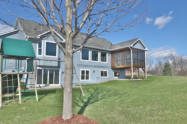 203 Walnut Hill Way, Troy Twp, WI 54022 - rear view of house featuring a lawn, a playground, and a sunroom