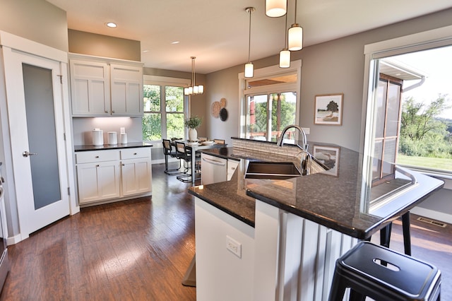 203 Walnut Hill Way, Troy Twp, WI 54022 - kitchen featuring dark wood-type flooring, white cabinets, recessed lighting, a breakfast bar, and pendant lighting