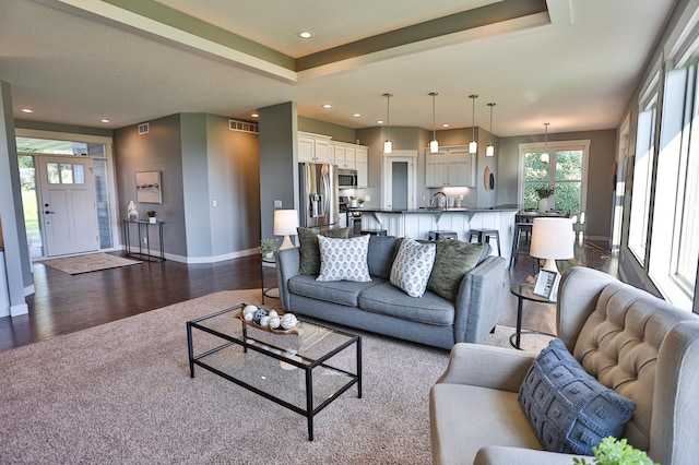 203 Walnut Hill Way, Troy Twp, WI 54022 - living area with healthy amount of natural light, dark carpet, dark wood-type flooring, and recessed lighting