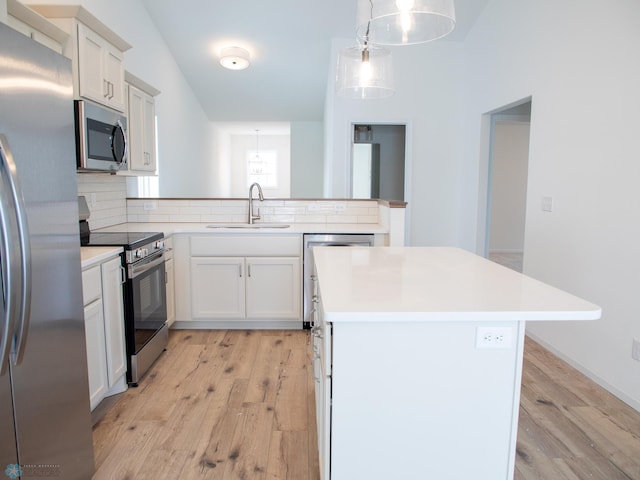 kitchen with decorative backsplash, stainless steel appliances, light wood-style flooring, and a sink