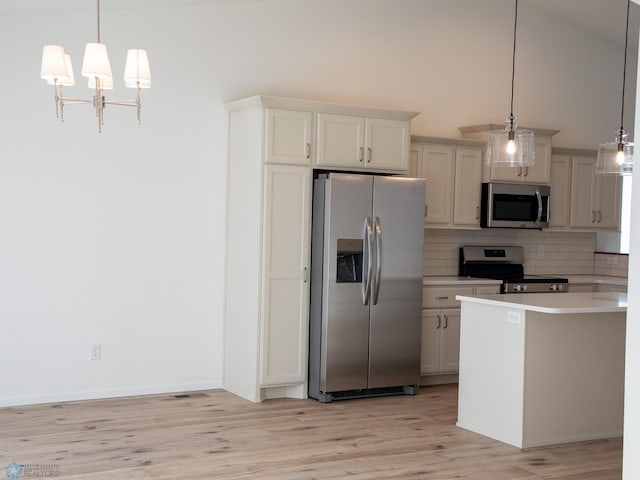 kitchen featuring stainless steel appliances, an inviting chandelier, backsplash, light countertops, and light wood-style flooring