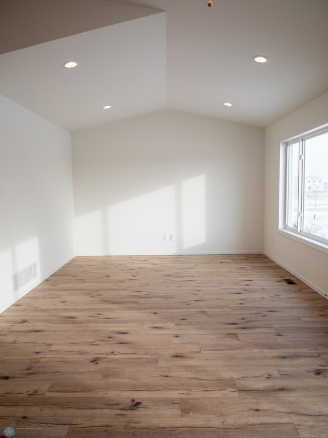 unfurnished room featuring wood finished floors, visible vents, and recessed lighting