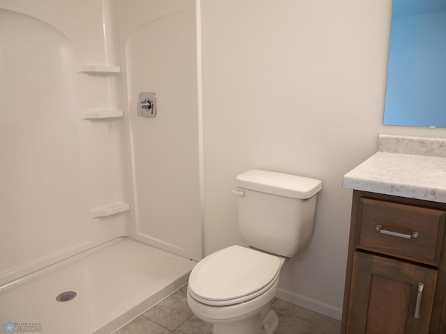 bathroom with toilet, a stall shower, vanity, marble finish floor, and baseboards
