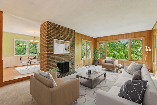1433 Oldridge Ave N, West Lakeland Twp, MN 55082 - living room featuring a chandelier, plenty of natural light, wood walls, light wood-style floors, and a fireplace