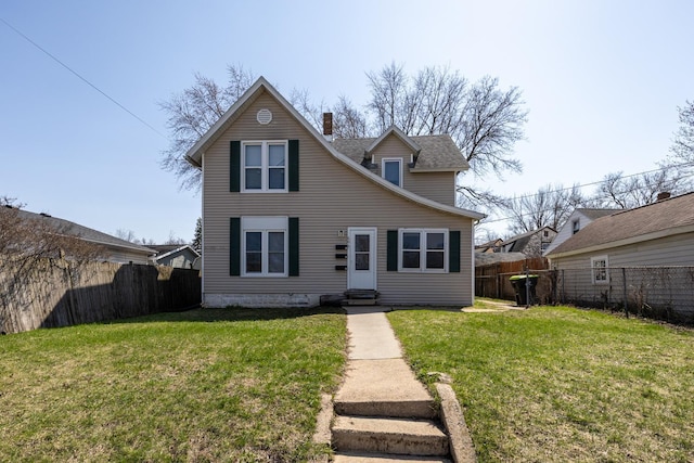 606 11th St SE, Rochester, MN 55904 - traditional home with a chimney, entry steps, a front lawn, and a fenced backyard