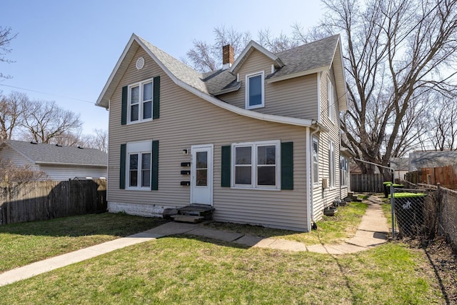 606 11th St SE, Rochester, MN 55904 - view of front facade featuring entry steps, a chimney, roof with shingles, a front yard, and a fenced backyard