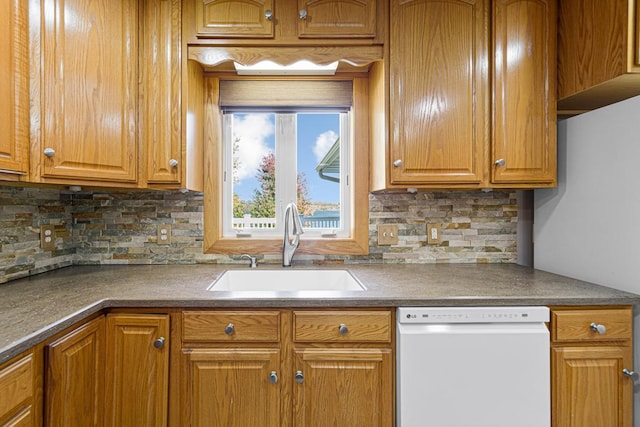 kitchen with tasteful backsplash, a sink, brown cabinets, and white dishwasher