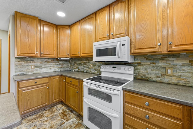 kitchen featuring brown cabinets, tasteful backsplash, and white appliances